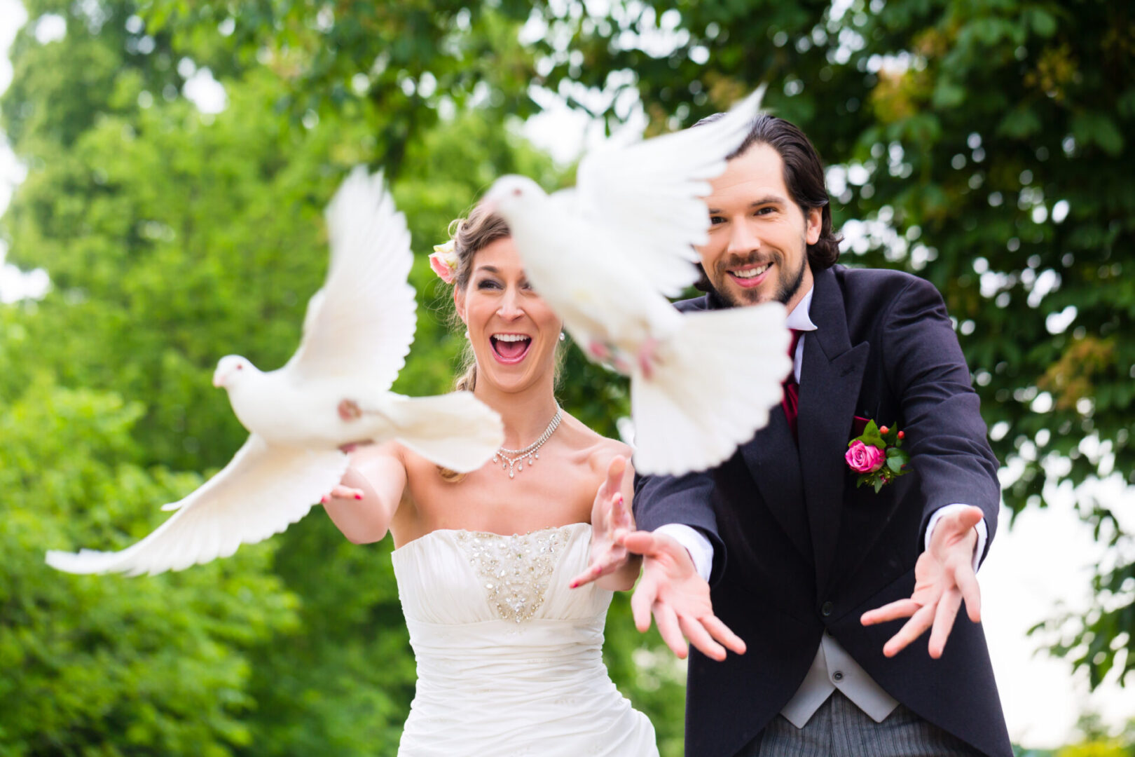 Bridal pair with flying white doves at wedding Bridal couple at wedding with white doves